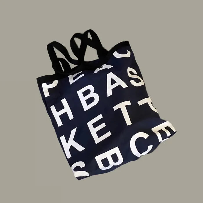 Flat lay of black Alphabet Canvas Tote Bag With Double Strap, ideal for errands and gifting.