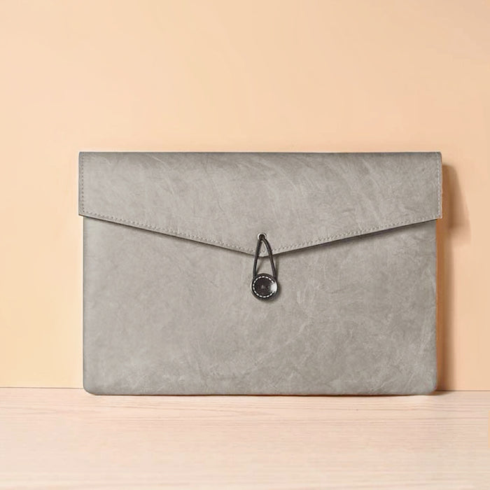 Angled view of Buttoned Envelope Laptop Sleeve bag in gray, great for everyday carry and travel.