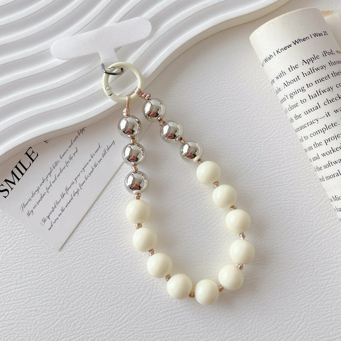 Close-up of Candy Bead Phone Charm in white, easy to attach to bags and phones.
