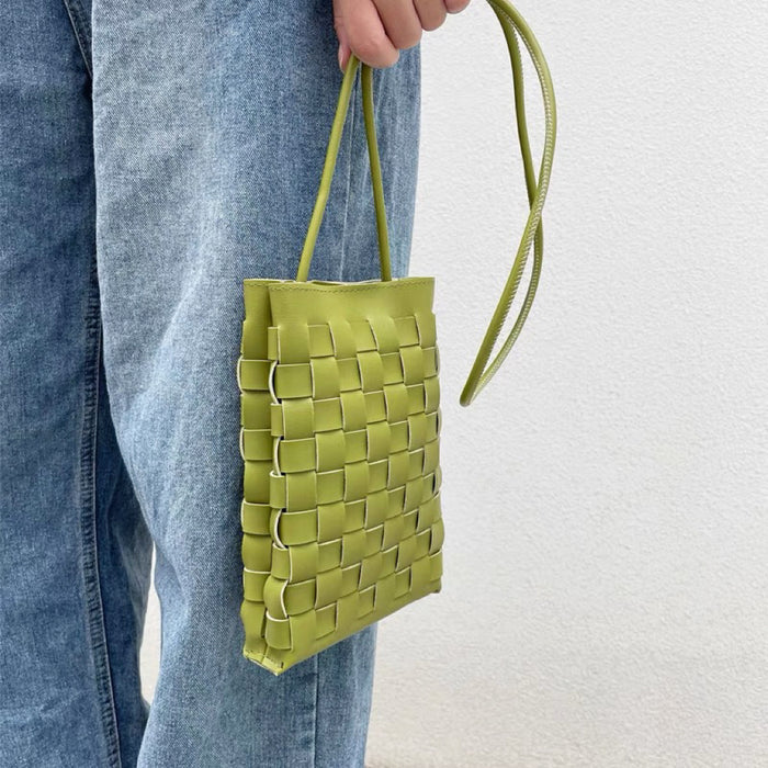 Model carrying a green crossbody bag handheld, ideal for city walks and gifting.