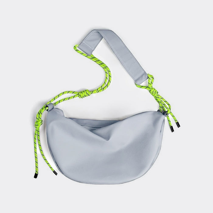 Front view of light grey nylon crescent bag with neon knotted strap detail, unique streetwear hobo bag.