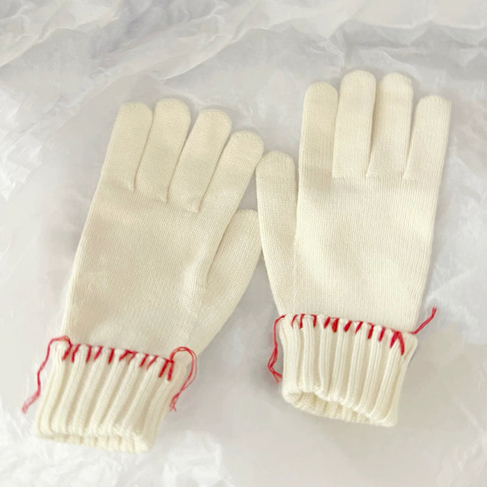 White colored-thread hemming gloves with contrast stitching; clean winter look for daily wear.