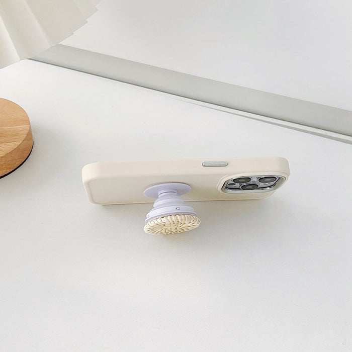 Front view of Creamy Case with Rattan Stand. Natural rattan texture on a protective soft-touch silicone body.