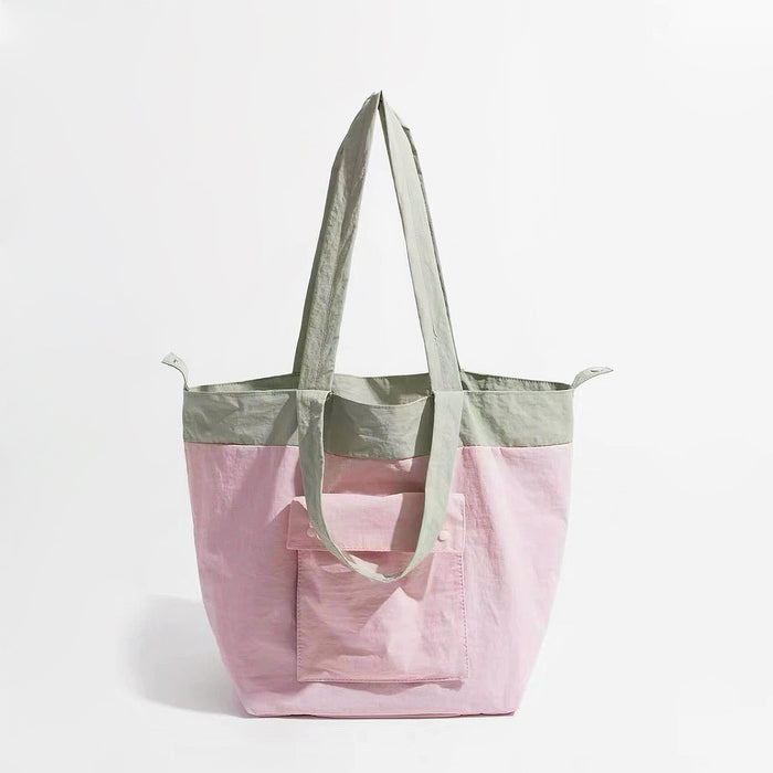 Folded view of Duotone Foldable Tote Bag in pink, easy for commuting and weekends.