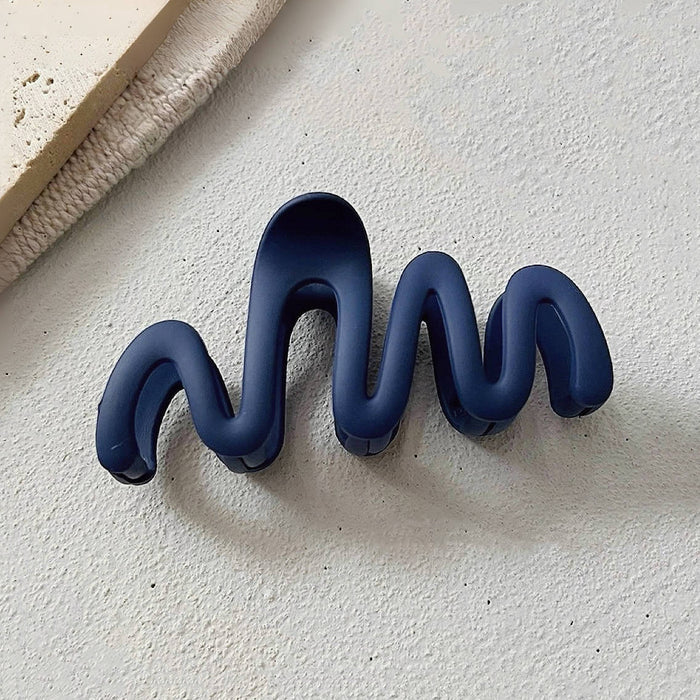 Close-up of Elegant Wave Hair Claw in blue, ideal for quick updos and ponytails.