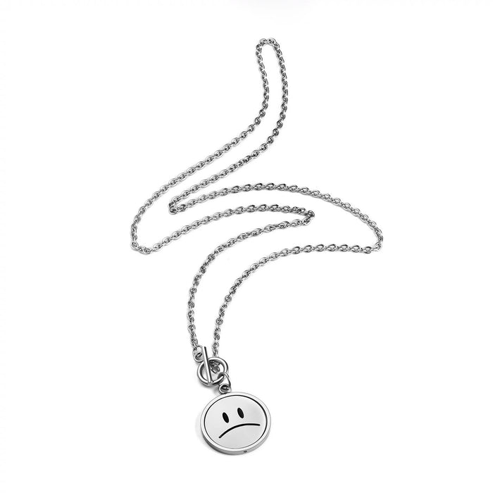 Back view of silver emoti spin necklace displaying the frowning face pattern
