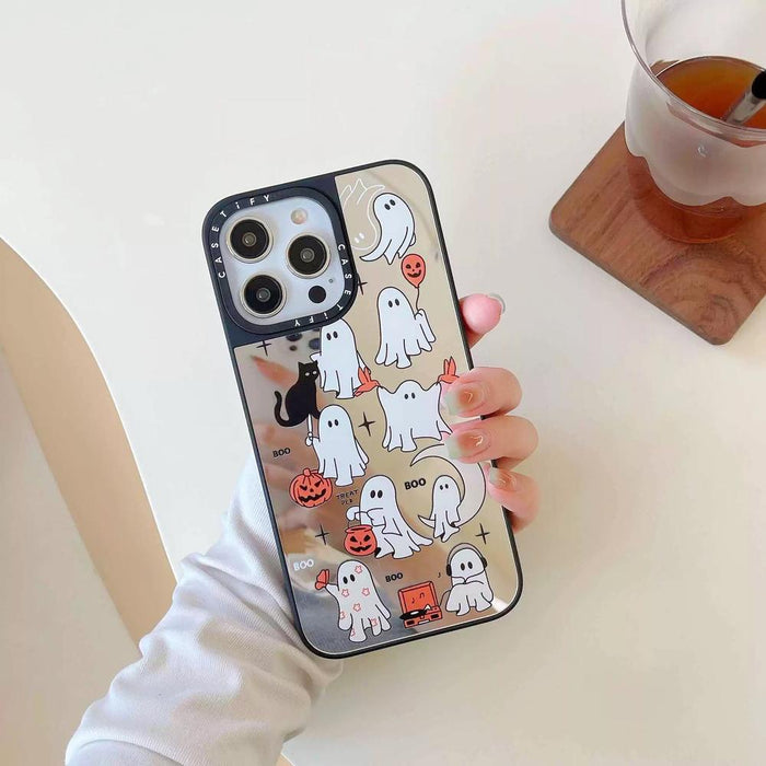 Model holding Halloween Mirror Case. High-shine reflective mirror finish with playful Boo typography.