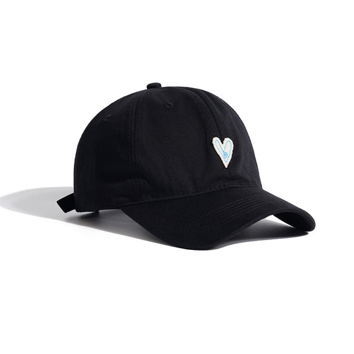 Classic black baseball cap featuring a delicate white heart embroidery detail.