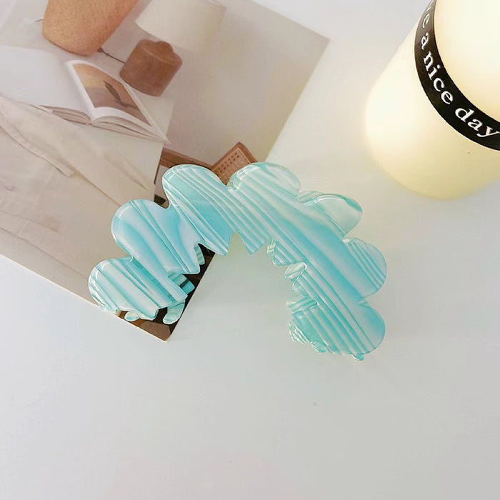 Angled view of Moon Hair Claw in blue, great for everyday styling and gifting.