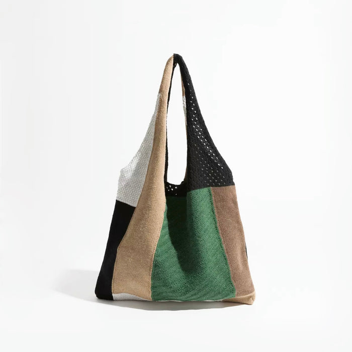 Front studio view of the crochet tote bag variant showcasing a mix of deep forest green, black, and beige knit panels.