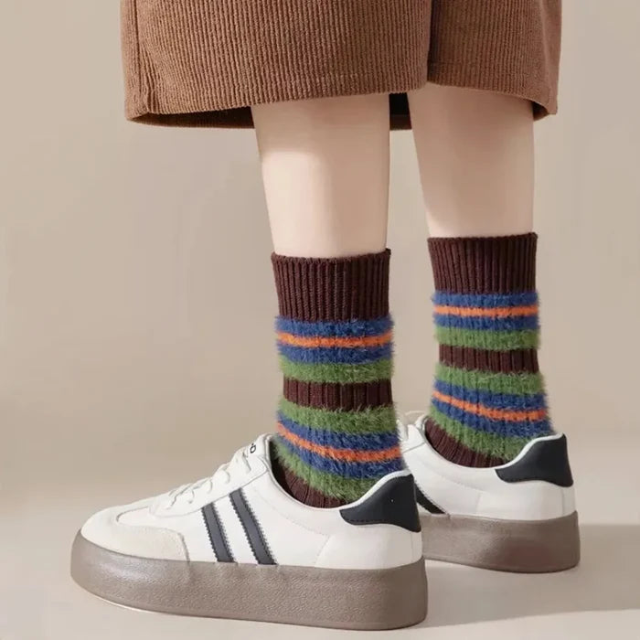 Model wearing a pair of Plush Striped Socks in brown, great for daily wear and lounging.