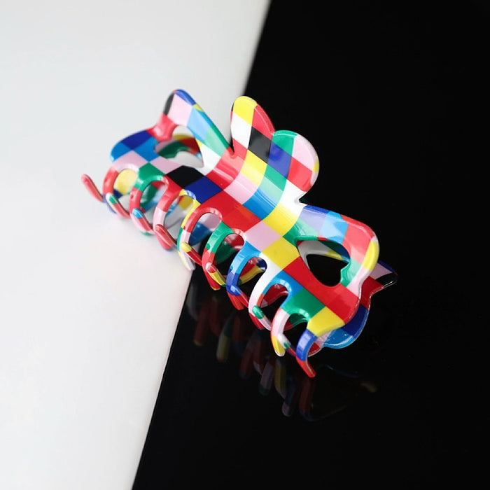 Flat lay of Rainbow Plaid Claw, easy for workdays and special occasions.