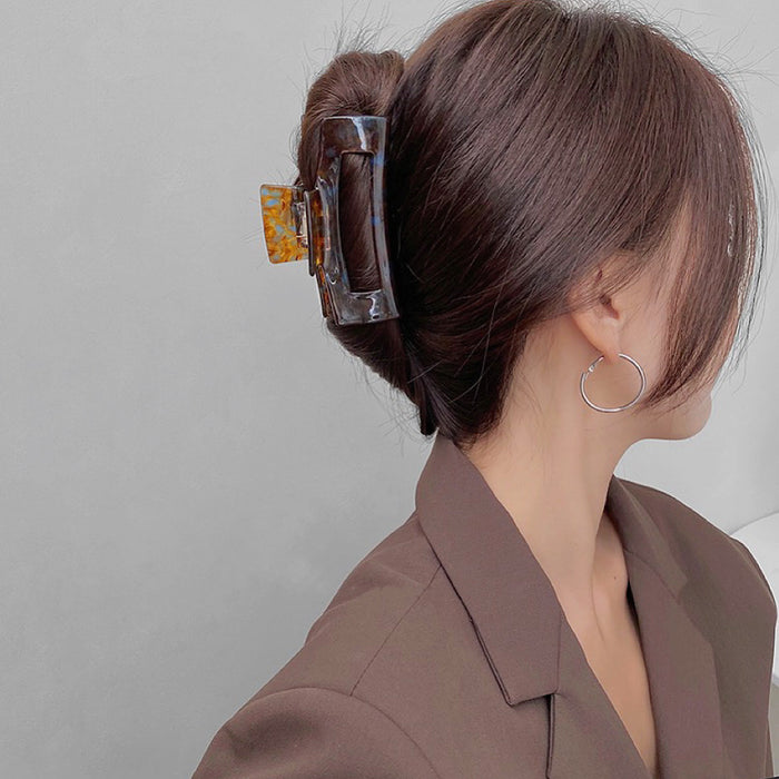 Model wearing a Retro Hair Claw in rectangle shape, great for everyday styling and gifting.