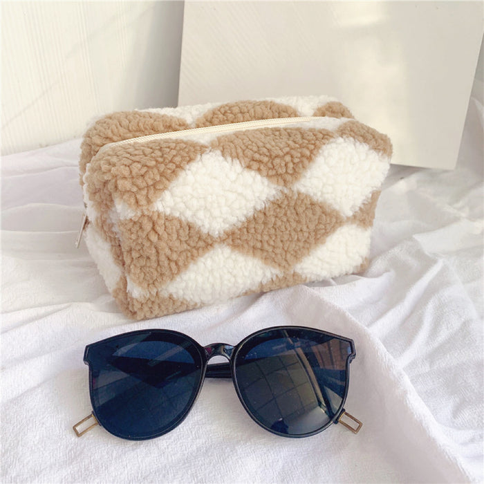 Angle view of sherpa teddy makeup bag in khaki , great for on-the-go touch-ups.