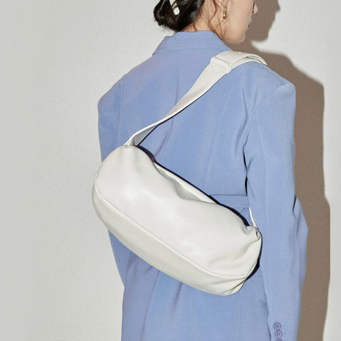 Model carrying a white Soft Leather Baguette Bag on the shoulder, ideal for city walks and gifting.