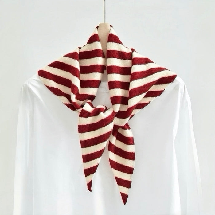 Angled view of red and cream white striped triangle wool scarf knotted for display, great for office layering.
