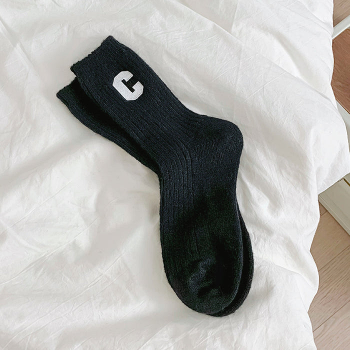 Angled view of Wool C Socks in black, great for daily wear and lounging.