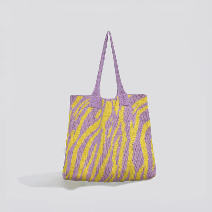 Angled view of Zebra Print Knitted Tote Bag in purple and yellow, great for everyday carry and travel.