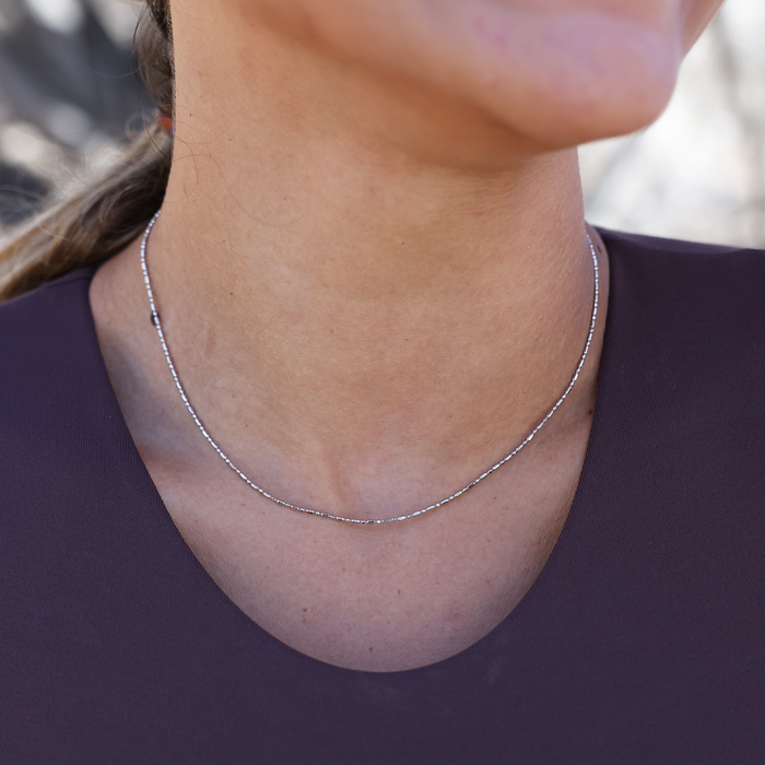Close up of a person wearing 1.0mm Ball Bar Chain in Sterling Silver
