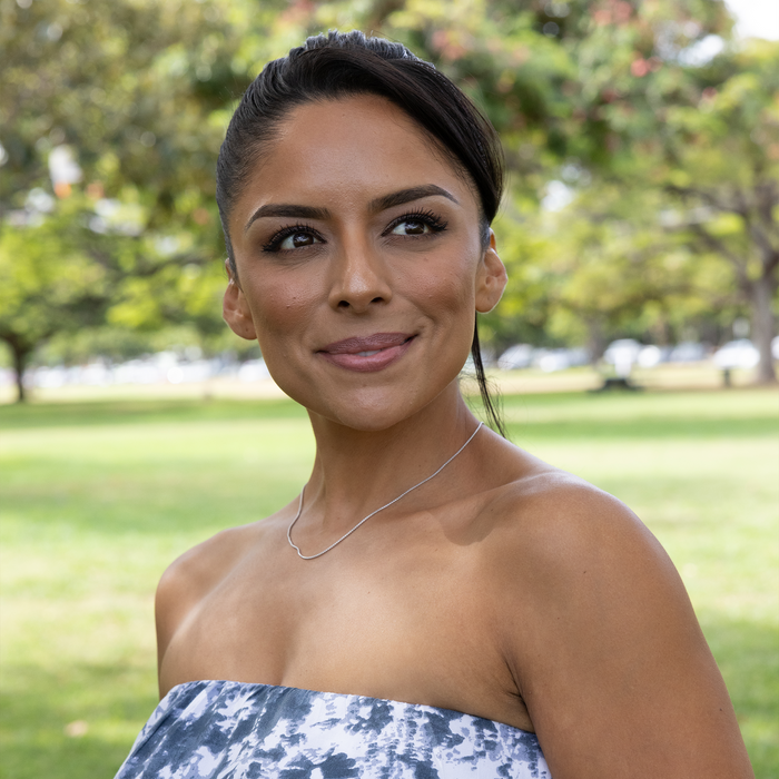 Woman in a park wearing a 1.2mm Round Box Chain in Sterling Silver
