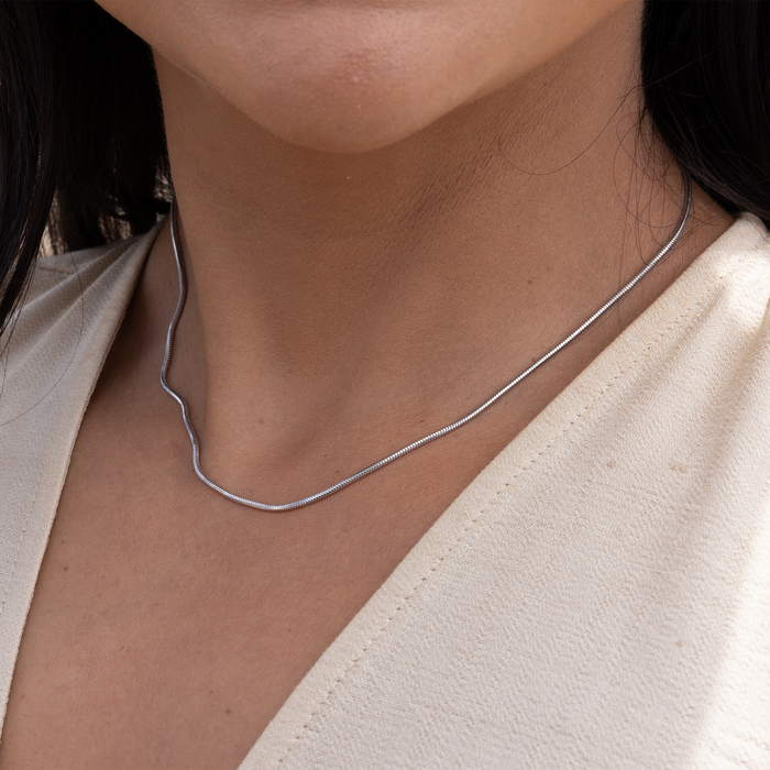 Close up of 1.4mm Snake Chain in Sterling Silver on a neckline