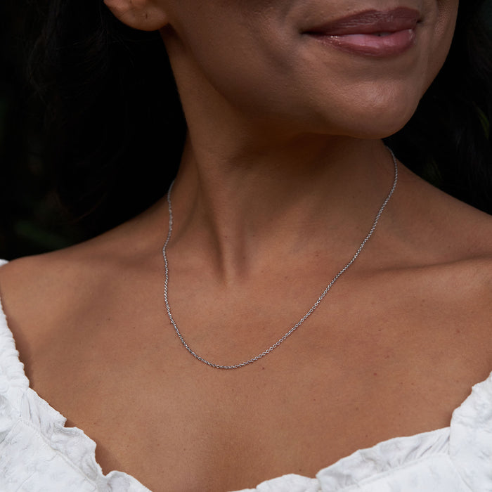 Adjustable 24" 1.0mm Cable Chain in Sterling Silver on a womanʻs chest