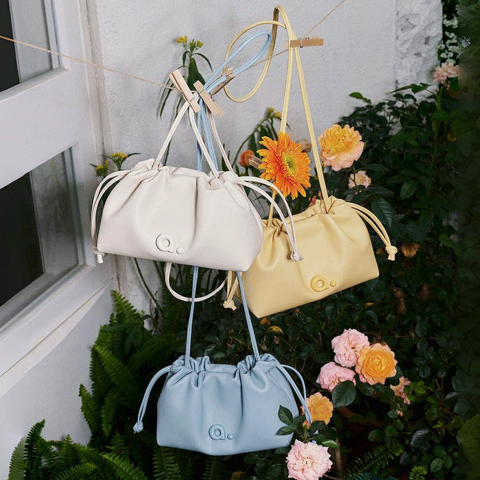 Front view of Three PU leather Mini Cloud Bags in cream, yellow, and blue.
