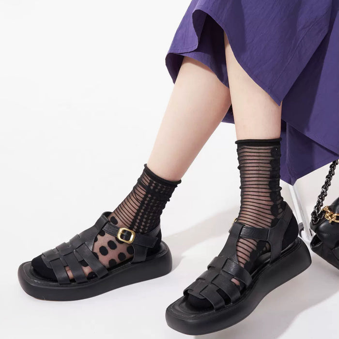 Model wearing a pair of Abstract Pattern Crystal Socks with black dots, great for casual wear and light workouts.