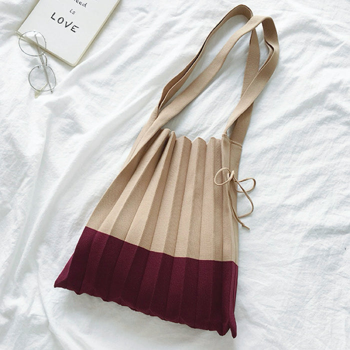 Folded view of khaki and burgundy accordion foldable knitted bag,  great for everyday.