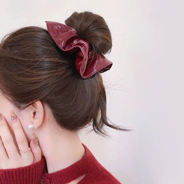 Model wearing an Ancora Red Leather Scrunchie, great for everyday styling and gifting.
