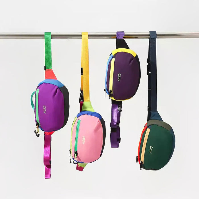 Four different colored AOIO flex belt bags hanging on a rack to show variety.