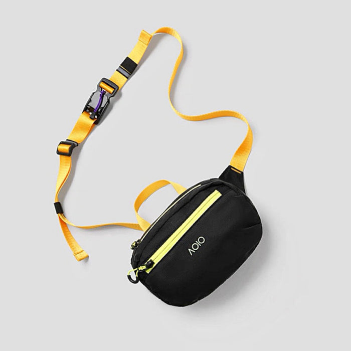 Detail shot of the black AOIO belt bag featuring a vibrant yellow strap.