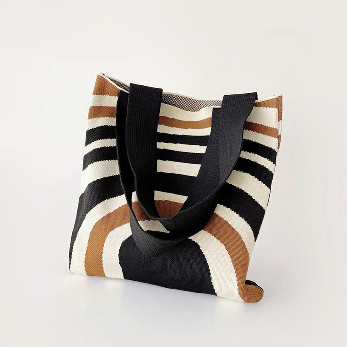 Front view of Arc Line Knitted Bag: Polyester fabric tote with black, white, and brown curved stripes.