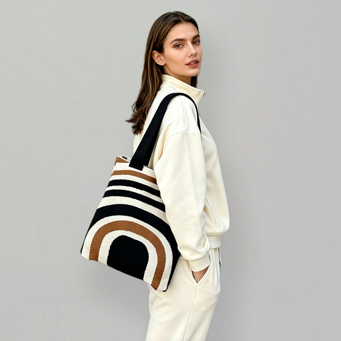 Model carrying a Arc Line Knitted Bag in black and khaki, easy for commuting and weekends.