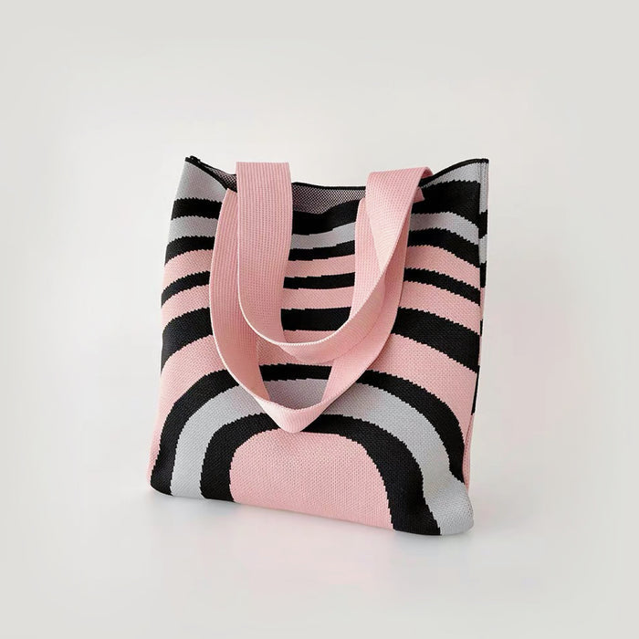 Close-up of  Arc Line Knitted Bag in pink and grey, ideal for errands and gifting.