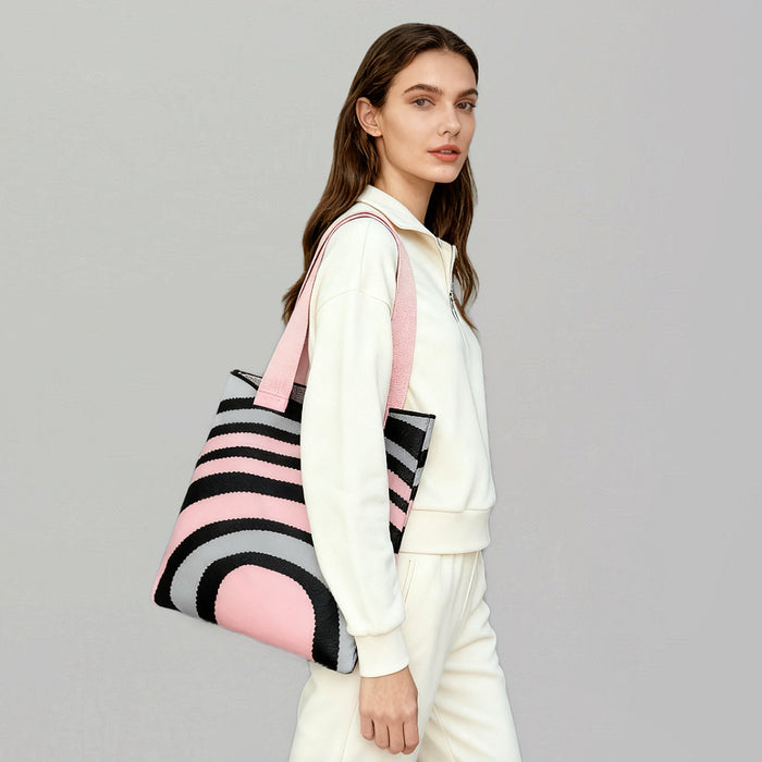 Model carrying a pink and grey Arc Line Knitted Bag on shoulder, great for daily carry and travel.