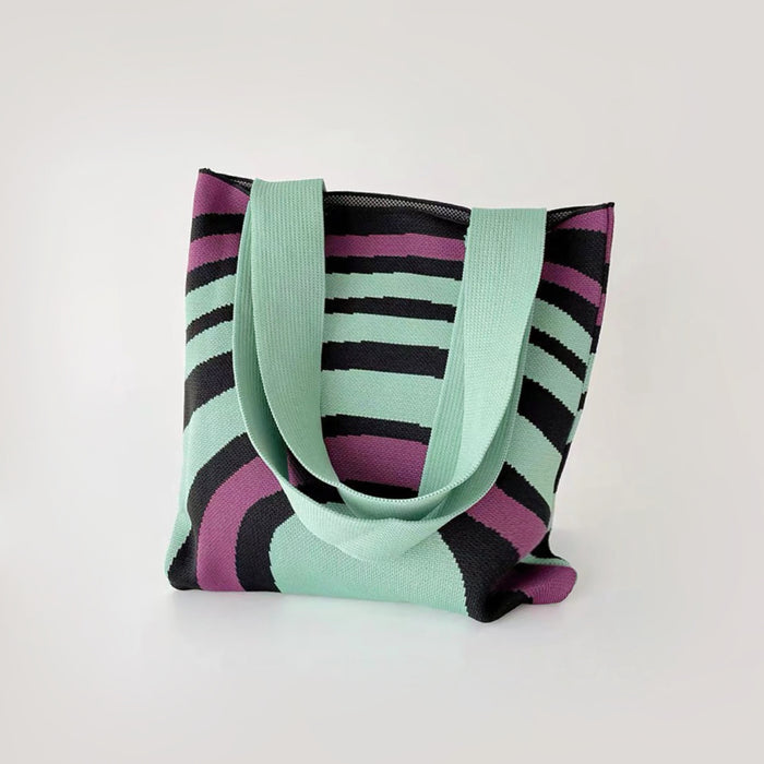 Folded view of Arc Line Knitted Bag in green and purple, easy for commuting and weekends.
