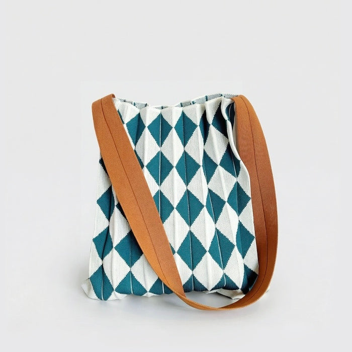 Close-up of Viridian-White argyle pleated knit bag, showcase stretchable fiber texture and pleated argyle pattern.