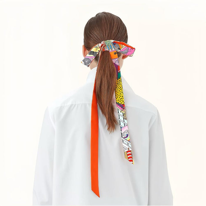 Model wearing a white shirt, with a colorful artistic print polyester skinny scarf tied in her ponytail in orange.