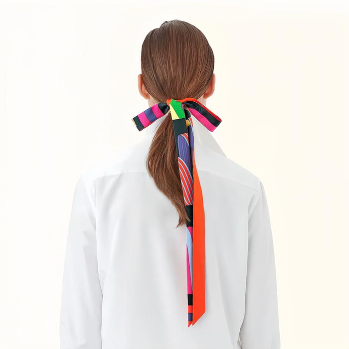 Model wearing a geometric polyester scarf in orange, easy for weekend styling and gifting.