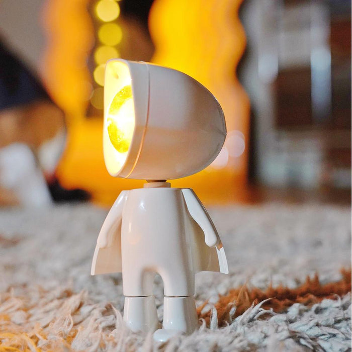 Astronaut atmosphere lamp with a sleek white body and LED sunset projection lens.
