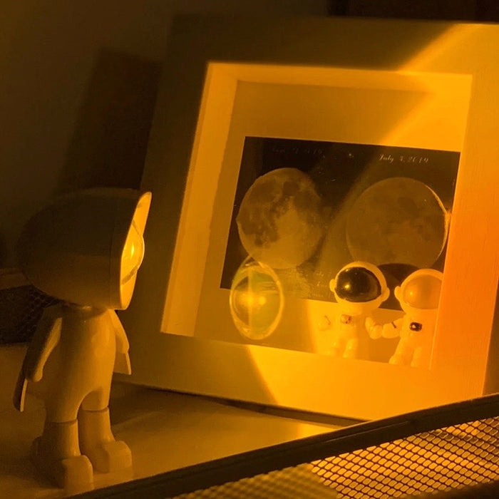 Mini astronaut lamp used as a bedside night light on the desk.
