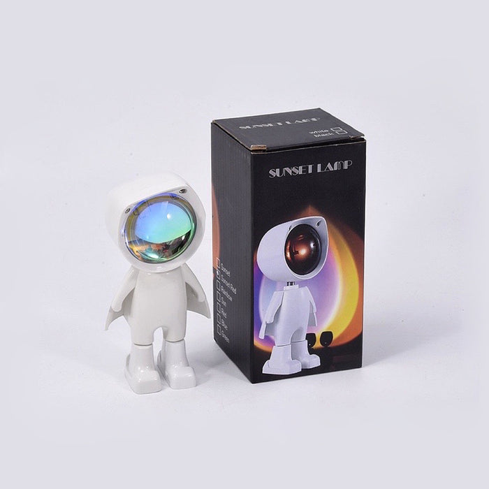 Astronaut atmosphere lamp shown with its original packaging and included USB charging cable.