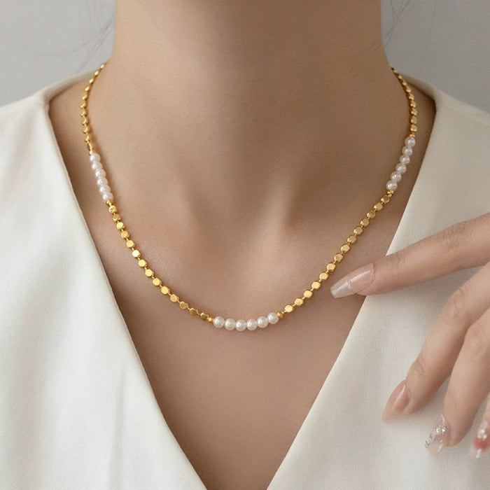 Close up of aurora pearl link necklace on model, showing high-luster gold chain detail