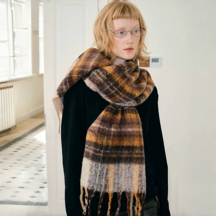 Model wearing a plaid wool scarf Autumn Ember Plaid Scarf, easy for weekend styling and gifting.