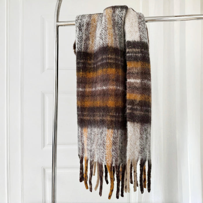 Flat lay of Autumn Ember Plaid Scarf in brown and yellow, great for office layering and commuting.
