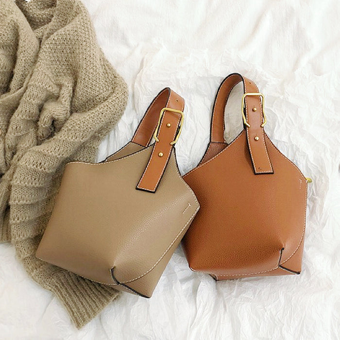 Front view of Two Balloon Bucket Bags: one khaki, one tan, with asymmetric design.