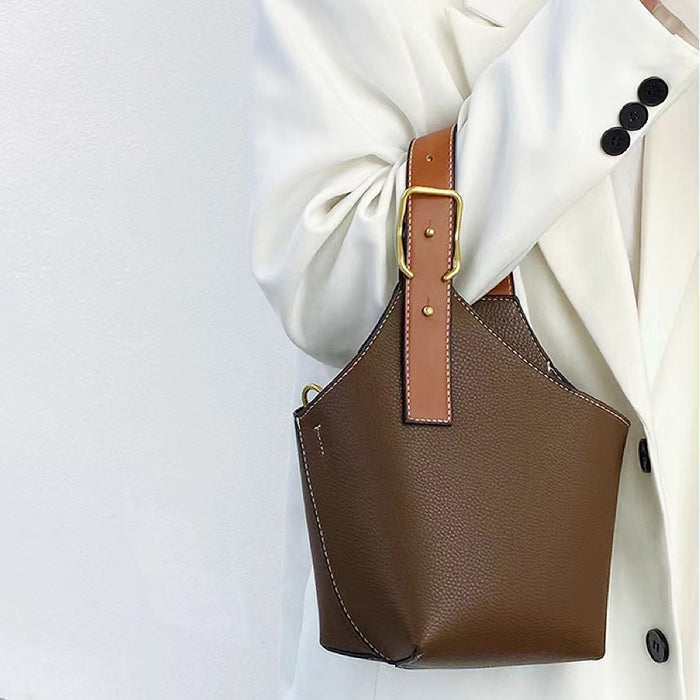Model carrying a coffee Balloon Bucket Bag, handheld, ideal for city walks and gifting.