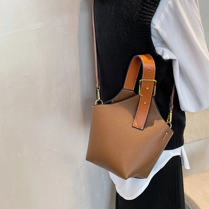 Angled view of model carring a tan Balloon Bucket Bag as crossbody bag, easy for commuting and weekends.