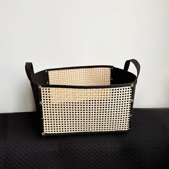 Folded view of Black fabric and natural woven bamboo foldable storage basket with handles.